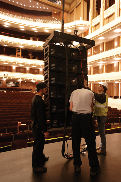 Assembling the main Meyer Sound speaker array in Reynolds Hall. From left, deck carpenter Kyle Warren, audio engineer John Wrote and assistant head carpenter Bob Stanley.