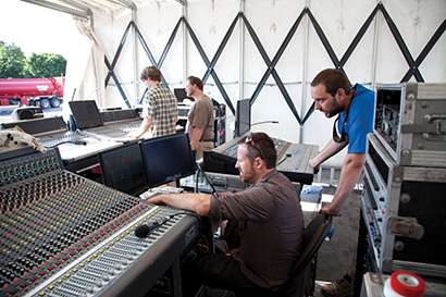 Solotech system techs David Vincent (kneeling at center) and Patrice Lavoie (in blue shirt) had their hands full, coordinating the audio details — including a sea of FOH consoles, both supplied and guest.