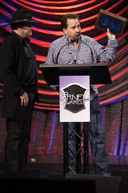 Francois Leroux of Solotech picks up the 2013 Parnelli Award for Sound Company of the Year. With him is host Micky Dolenz. Photo by Adam Kaplan.