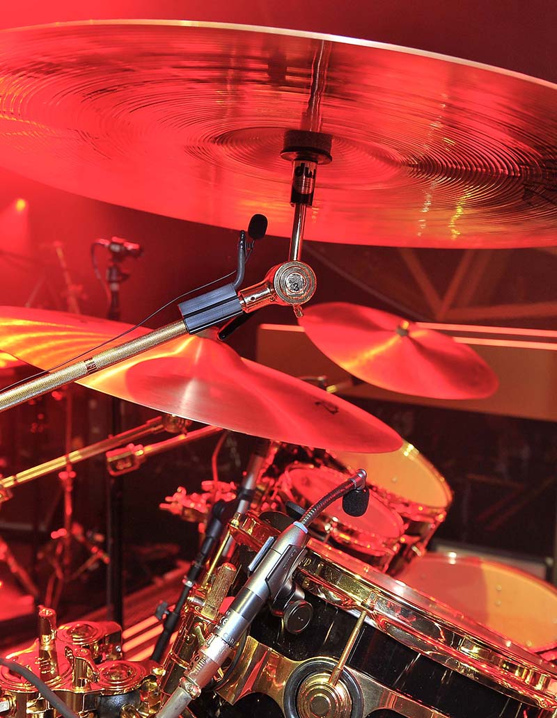 Cymbals were under-miked so overhead booms wouldn't block the large video screen. Photo by Steve Jennings