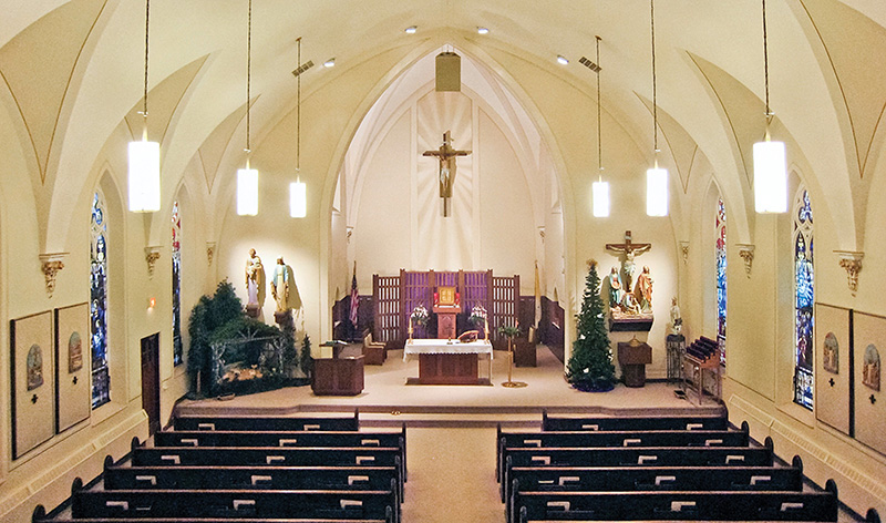 During the 1970’s the structure was stripped down with a modern look, including a very noticeable center cluster at the peak of the arch above the altar.