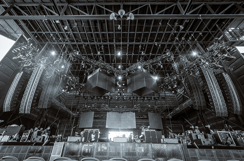 Wide view of stage reveals JBL VTX V25 left/right hangs, flown S28 subs and side hangs. Photo by Vic Wagner