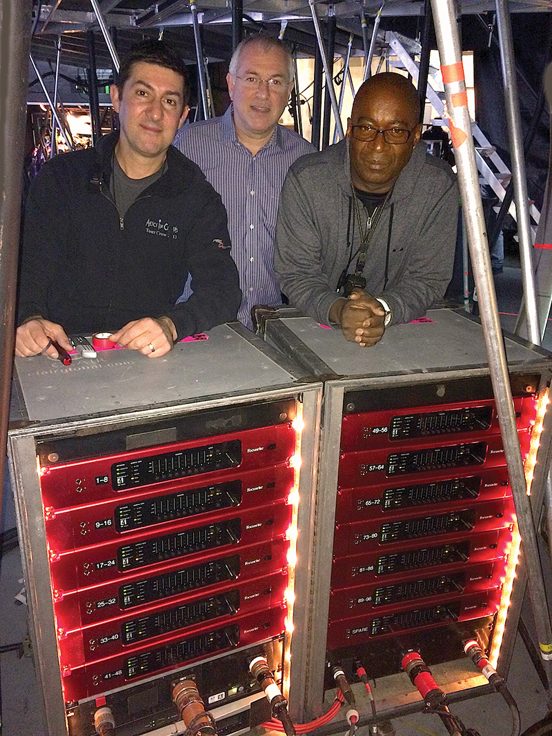 Under the stage during setup at the Staples Center in L.A. with 96 channels of Focusrite RedNet-4 preamps are (L-R) Clair Global systems engineer Frank Scambellone, Focusrite USA president Phil Wagner and FOH mixer Horace Ward.