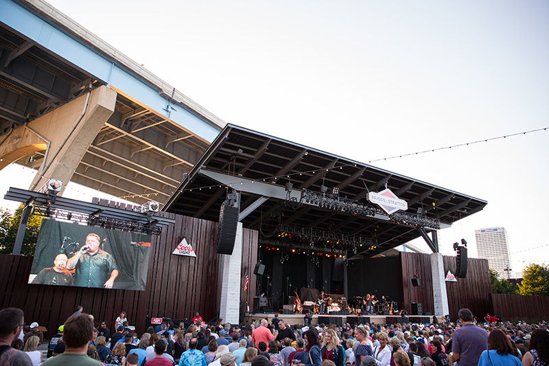 This photo of the Briggs and Stratton Big Backyard stage during the day shows the JBL hangs in use.