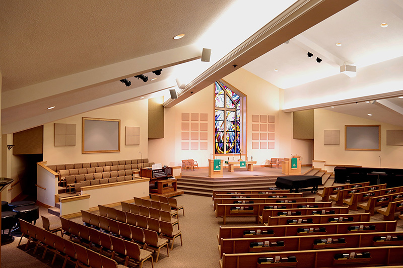 Multiple reflective surfaces within the sanctuary required acoustical treatment