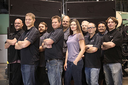 Chris and Hyacinth Belcher (front center) with Onstage Systems’ audio crew in front of a few “old friends”
