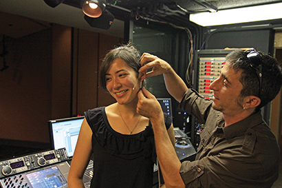 Alan Ceccarelli placing an E6 Omni Earset Microphone on a student