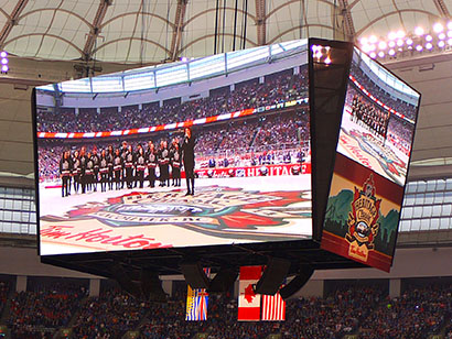 A jumbo screen view of Sarah McLachlan and her students leading out “O Canada” at the 2014 NHL Heritage Classic on March 2 (photo credit: juhan88)