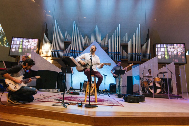 A worship band performs at St. Andrew’s Presbyterian Church, in Newport Beach, California. Visible in background are two new DaLite 10x13-foot screens, sourced through GC Pro, along with four Panasonic PTDZ21KU 3-Chip DLP projectors (not pictured).