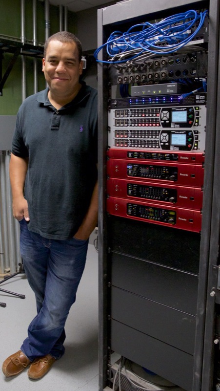 Jacob Moore, Creative Director of Beltway Park Baptist Church in Abilene, Texas, pictured with the church’s AV rack, featuring Focusrite RedNet interfaces. Photo courtesy of Jacob Moore. © 2015. 