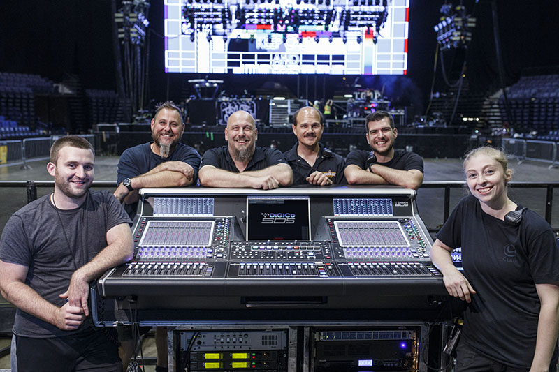From left, Chris King, monitor tech; Jerrell Evans, systems engineer/crew chief; Chad Olech, FOH engineer; Tim Banas, PA tech; Kevin Dennis, monitor engineer; and Katie Hughes, PA tech at the DiGiCo SD5 FOH console out on Fall Out Boy's current tour. Photo by Jack Edinger