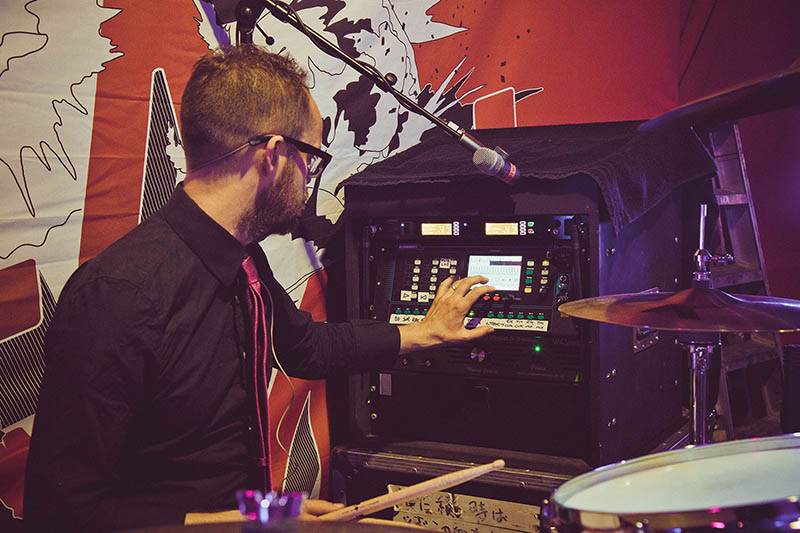 Irish rock band, Ash, is currently on tour supporting their 2015 album, Kablammo , with Allen & Heath’s ultra-compact Qu-Pac digital mixer managing monitor sound. The band’s FOH engineer, Alan “Hagos” Haggarty, and drummer/monitor engineer, Rick McMurray (pictured here), both cited the setup as a significant improvement over the analog status quo.