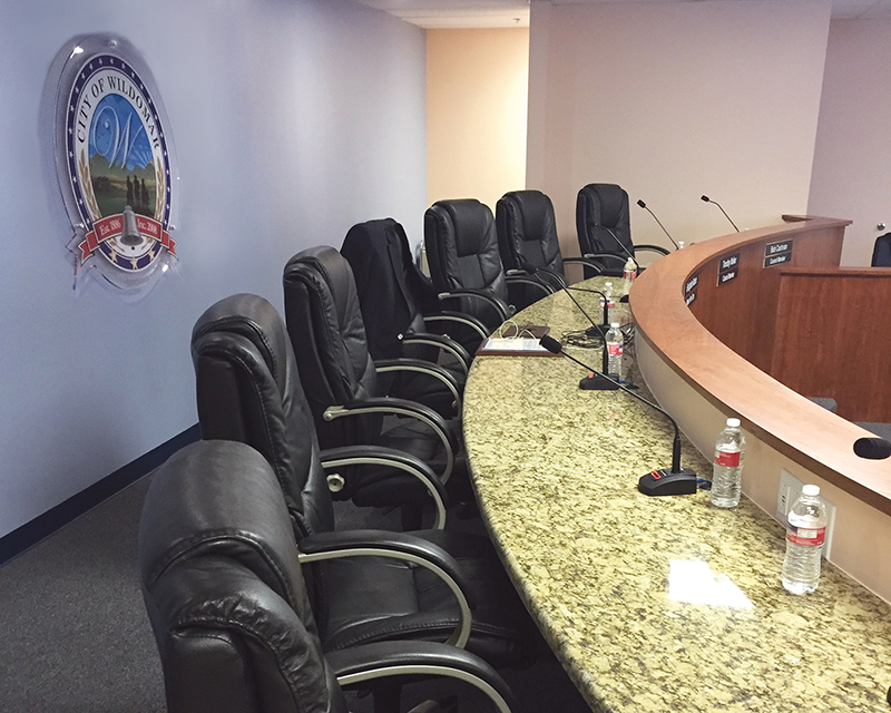 A view of the city council chambers in Wildomar, CA, featuring Audio-Technica U857QL Cardioid Condenser Quick-mount Gooseneck Microphones, each attached to an A-T ATND8677 Microphone Desk Stand with Dante network output.