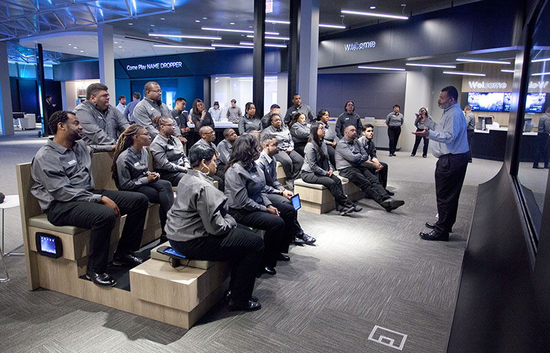 Comcast associates attend an in-store training before the launch of the Xfinity Studio in Chicago.