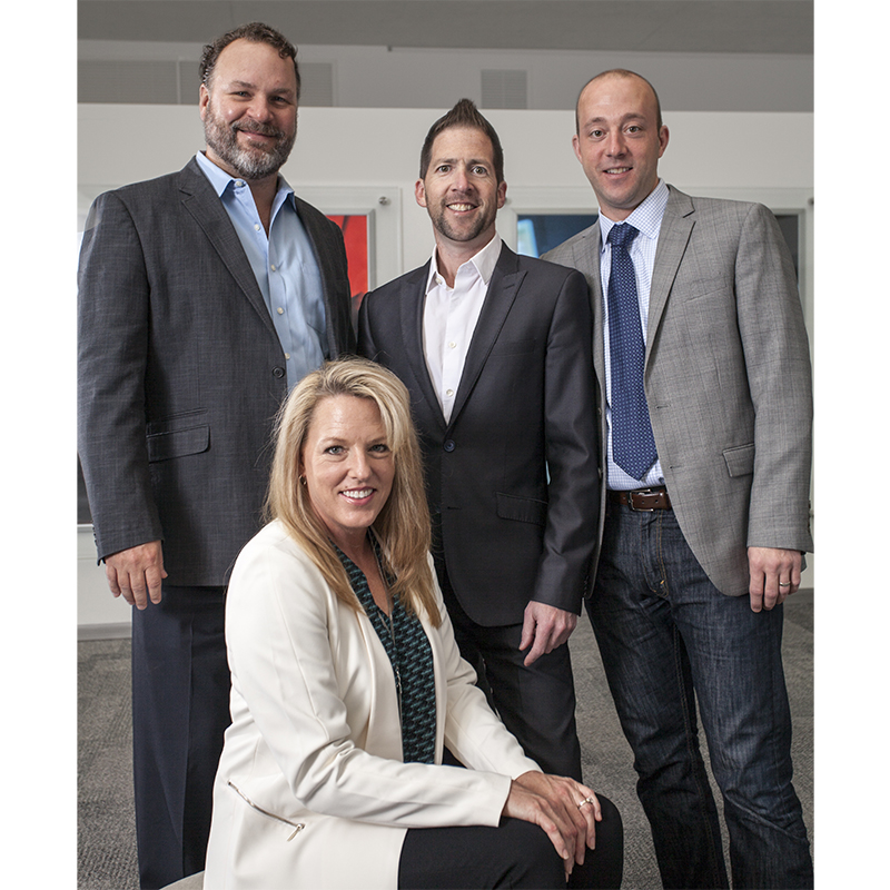 Shure Names Livella Brand Group as its Sales Rep Firm for the Central U.S. Pictured here, standing, from left: Rick Renner (Shure Inc.), Adam Livella, Brian Jarvis (Shure Inc.). Seated: Karin Livella