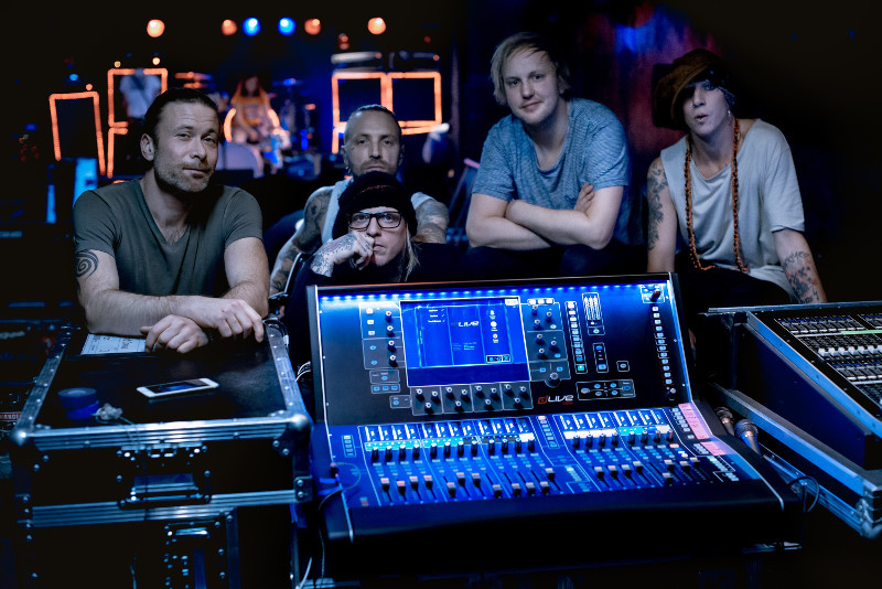 FOH engineer Stefan Ljungkvist (center) is pictured here with the band members and the dLive S3000 console.