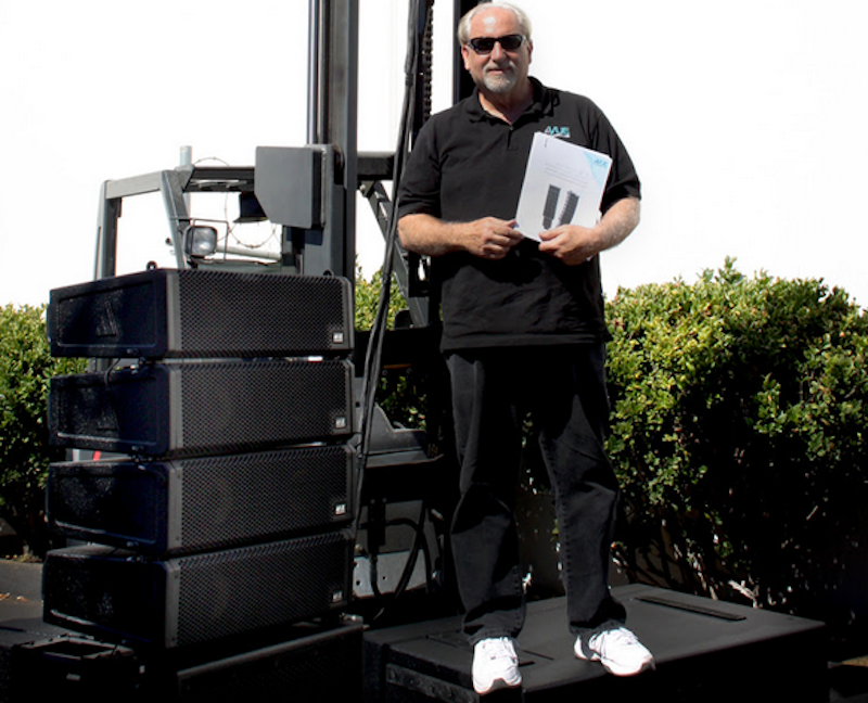VUE Design Chief Michael Adams being a good sport holding the white paper and standing atop a hs-221 ELF Subwoofer System.