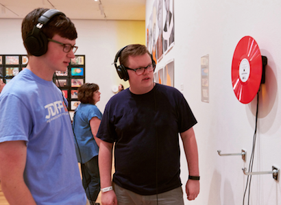 Attendees at the exhibit’s opening, using Audio-Technica ATH-M20x Professional Monitor Headphones, to hear music composed by Mothersbaugh, including selections from The Royal Tenenbaums, The Life Aquatic with Steve Zissou, The Lego Movie and more. Photo: Todd Biss Photography.