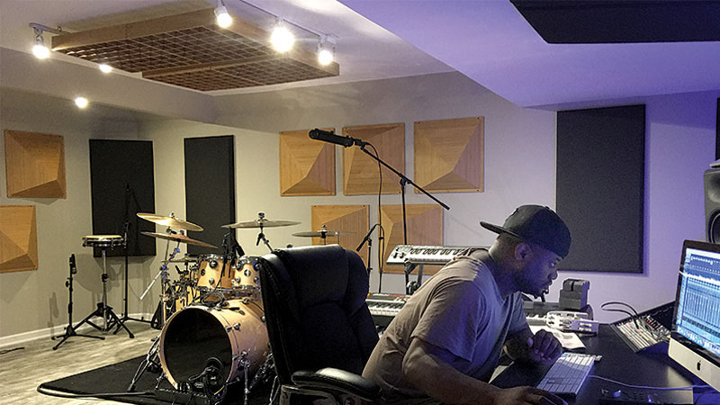 Derrick Wright, pictured in his personal studio, outfitted with acoustical treatment solutions from Auralex®.