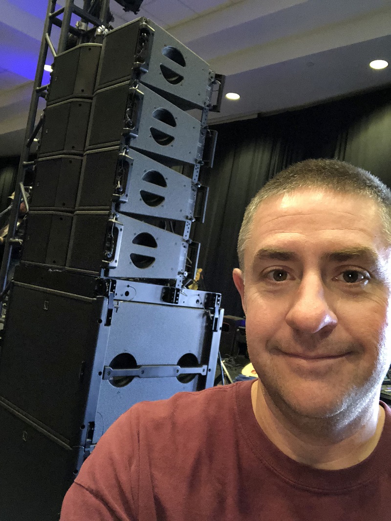 Axiom Audio CEO Ben Bruce with a stack of L-Acoustics Kara and SB18 enclosures at a recent Billy Ray Cyrus show