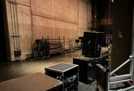 The backstage monitor setup with an EAW top cabinet and a double-18" subwoofer behind the orchestra shell and aimed at the venue's reflective back wall, creating a large reverb chamber