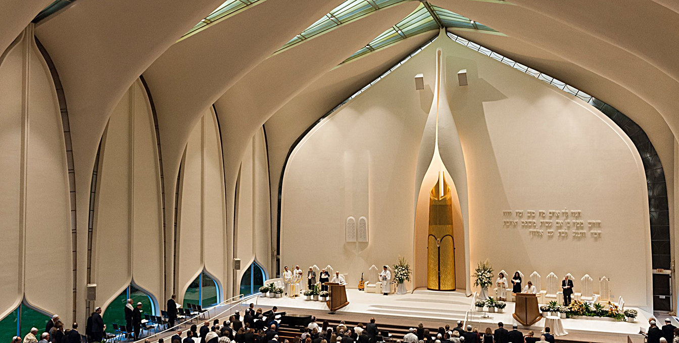 Still visible in this picture, the sanctuary’s original sound system, with two speakers located high above the altar were distanced well away from the congregation and created a massive reverberant field that greatly reduced intelligibility. 
