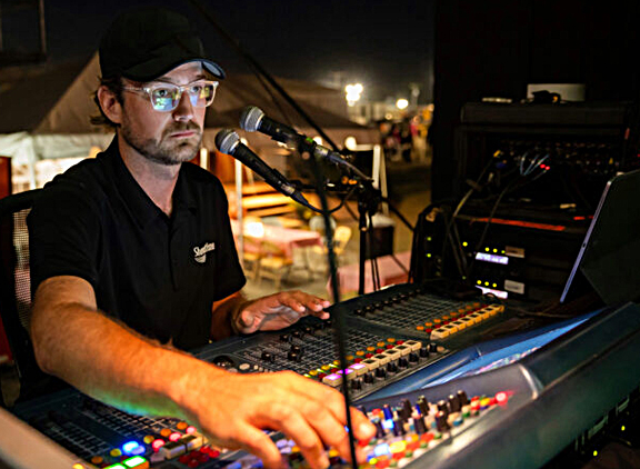 Showtime team member Patrick Firestein mixes monitors for opener, The Red Clay Strays.