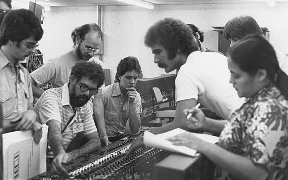 Glenn Coleman (center, in white t-shirt) doing MCI console training in 1979.