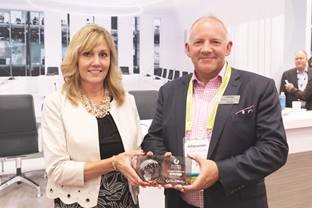 Chris Schyvinck, (Left) President and CEO at Shure receives the Global Excellence Award from Julian Phillips (Right) Executive Vice President at Whitlock, who also serves as the Chairman of the Board of Directors for AVIXA.